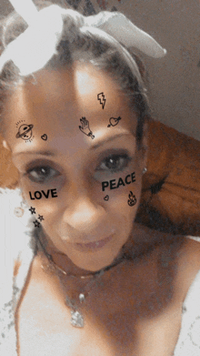 a woman with stickers on her face including peace and love