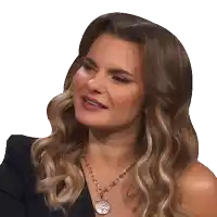 a woman wearing a necklace with a coin pendant on it