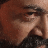 a close up of a man 's face with sweat coming out of it