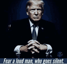 a picture of donald trump with the words fear a loud man who goes silent behind him