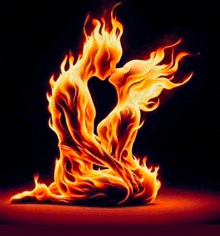 a man and a woman are surrounded by flames and kissing each other .