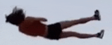 a person is laying on their back in the air with their legs crossed