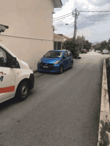 a blue car is parked on the side of a road