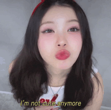 a girl making a funny face with the words i 'm not cute anymore written below her