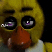 chica the chicken from five nights at freddy 's is making a funny face .