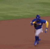 a baseball player is laying on the ground while a referee watches .