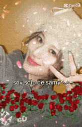 a woman is surrounded by red roses and says soy solo de samy aa