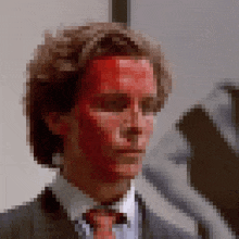 a pixelated image of a man with red blood on his face