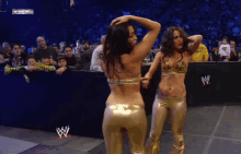 two women are dancing in front of a crowd at a wrestling show on wwe hd