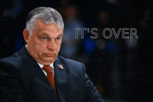 a man in a suit and tie with the words it 's over below him