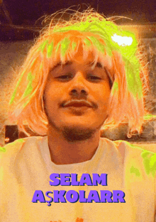 a man wearing a pink wig and a white shirt that says selam askolarr