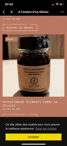 a phone screen shows a bottle of phyto-elements