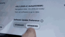 a person is pressing a button on a computer screen that says software update preference