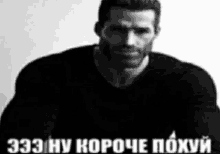 a black and white photo of a man with a beard wearing a black shirt and a caption in russian .