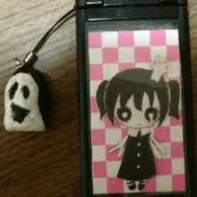 a cell phone with a picture of a girl and a ghost on it