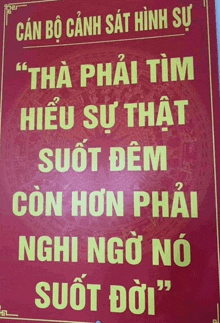 a red sign with yellow letters that says " can bo canh sat hình sự "