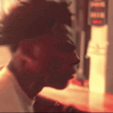 a close up of a man 's face in a blurry photo with a red background .