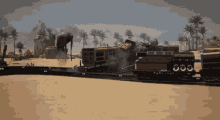 a train is going down a track in the desert with a statue in the background