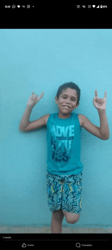 a young boy wearing a blue tank top that says adventure