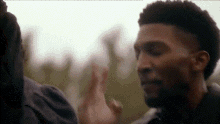 a man and a woman are giving each other a high five