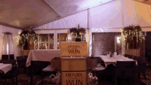 a restaurant with tables and chairs and a sign that says ' meisjes van de wijn '