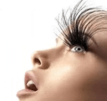 a close up of a woman 's face with long fake eyelashes .