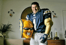 a man wearing a number 1 jersey is holding a yellow mask