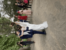 a bride and groom are dancing in front of their wedding party