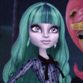 a monster high doll with green hair is standing next to another doll
