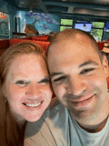 a man and a woman are posing for a selfie in a restaurant .