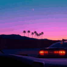 a car is parked in front of a sunset with palm trees in the foreground