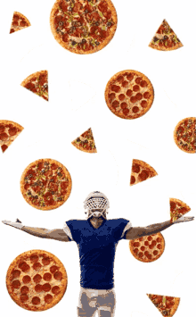 a football player with his arms outstretched is surrounded by pizza