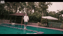 a man is standing on a raft in a swimming pool with the words nakalchi hote bandar on the bottom