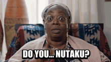 a woman sitting in a chair with the words " do you nutaku " on her face