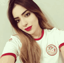 a woman taking a selfie wearing a white shirt that says tunisia on it