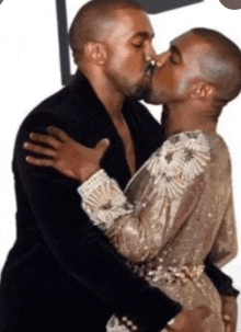 two men are kissing and one of them is wearing a gold dress