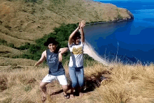 a man and a woman are dancing on top of a hill with a woman wearing a shirt that says chicago