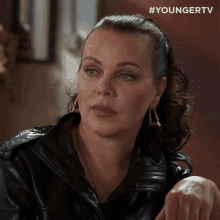 a woman wearing a black leather jacket and earrings with the hashtag youngertv on the bottom