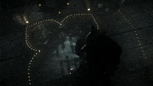a man stands in front of a heart shaped display of lights