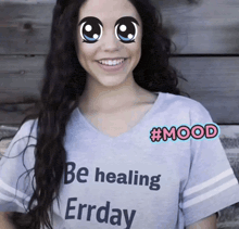a woman is wearing a shirt that says be healing errday