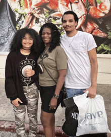 a family posing for a picture with a bag that says 10wave on it