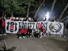 a group of men holding a banner that says korfez cadsi 1903