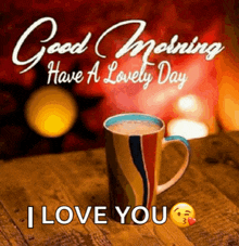 a cup of coffee is sitting on a wooden table with the words good morning have a lovely day i love you