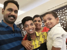 a family posing for a picture with a boy wearing a shirt with givenchy on it