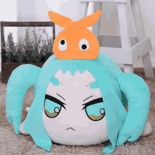 a stuffed animal with a fish on top of it 's head