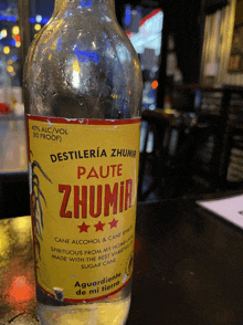 a bottle of zhumir cane alcohol is on a table