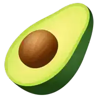 a green avocado with a brown seed in it