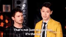 two men are standing next to each other and one of them is saying that 's not just my opinion it 's the law