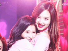 two women are hugging each other and the kbs logo is visible in the background