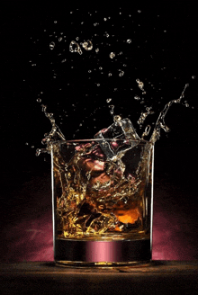 a glass of whiskey with a splash of ice